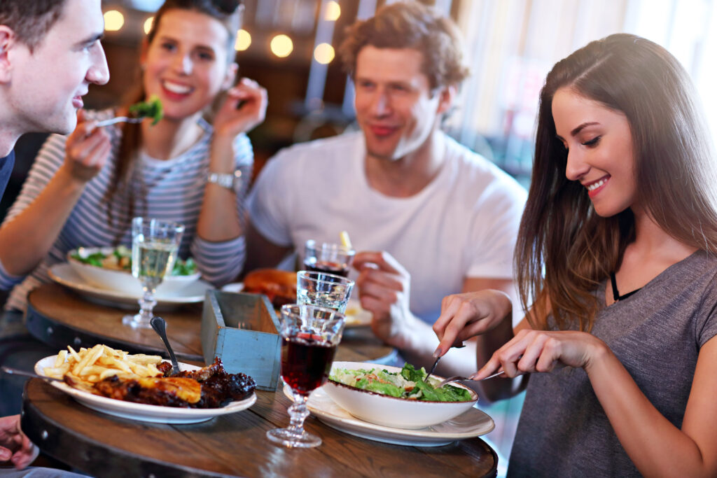 Planning a Trip to Melbourne. Group Of Friends in Melbourne Enjoying Meal In Restaurant