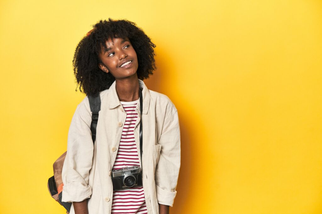 Teen girl with backpack, camera, ready for vacation dreaming of achieving goals and purposes. Darwin Visitor Guide