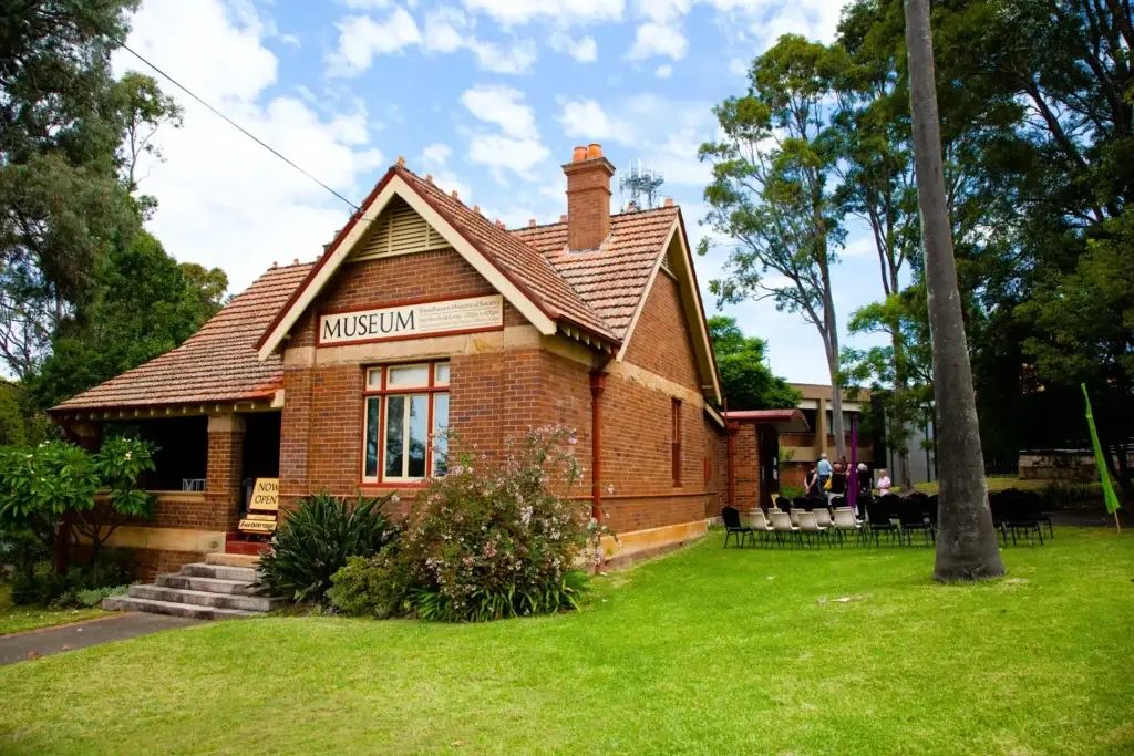 Nowra museum surrounded by lush green grass and bushes