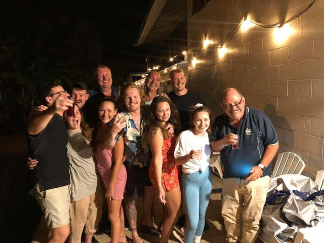 a bunch of happy travellers socialising and posing for a photo at Cstay Guest House on Magnetic Island