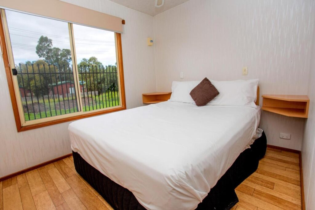 A private room with queensized bed in one of the cabins at Discovery Parks Geelong