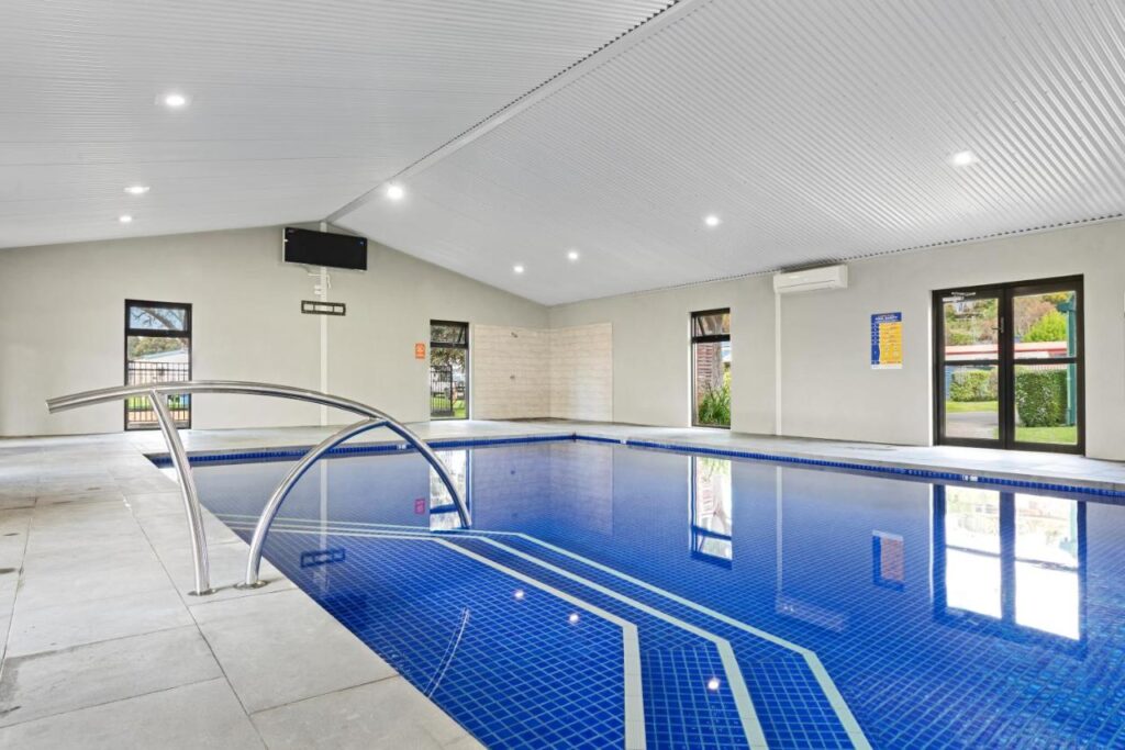 Indoor swimming pool facilities with deep blue tiles at Discovery Parks - Geelong