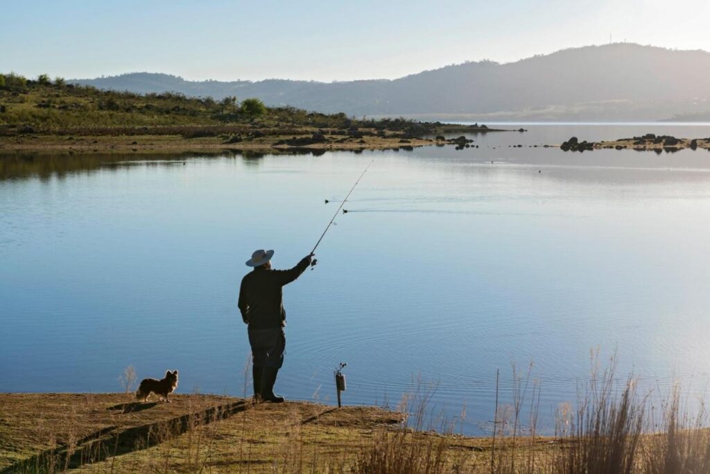 A guest spending the day fishing at Discovery Parks Jindabyne 