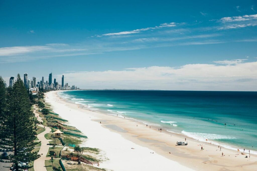 A long coastal and tropical beach with blue water and awesome waves at Nobby Beach Holiday Village 