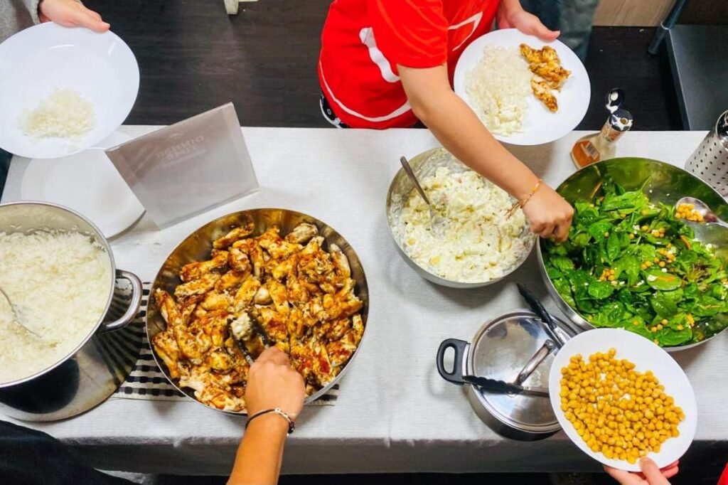 Travellers cooking a delicious and healthy dinner at Tequila Sunrise Hostel Adelaide