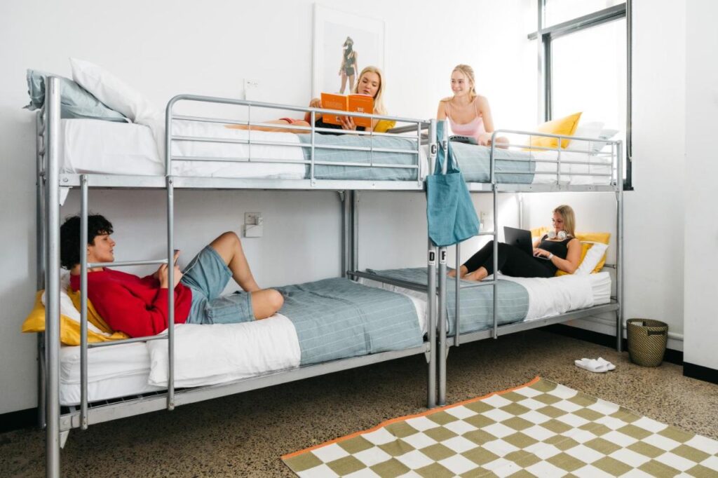 Travellers socialising while relaxing in the dormitory at The Village Glebe