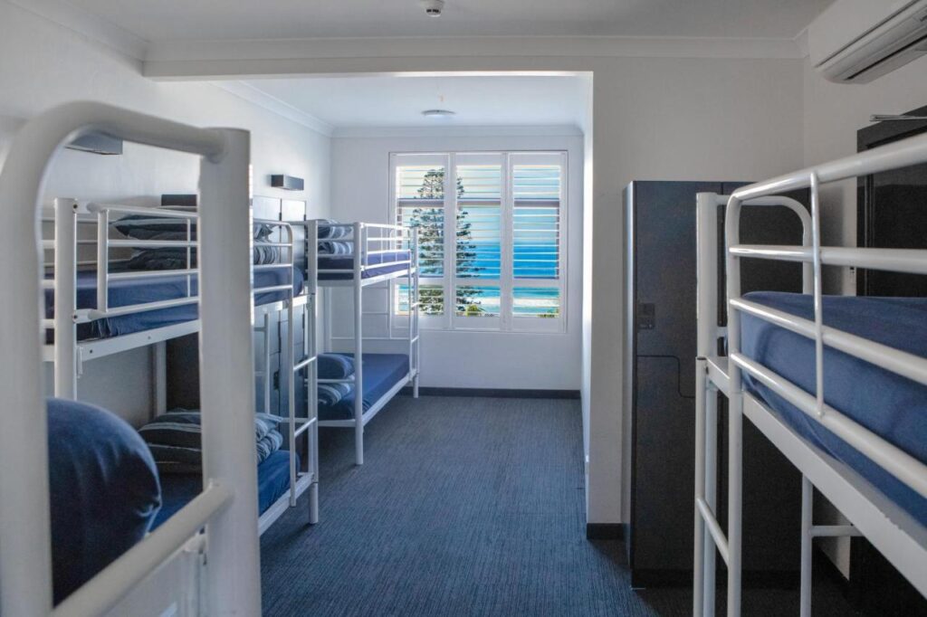 An eight person dormitory with views looking out to ward the ocean at Wake Up! Bondi Beach