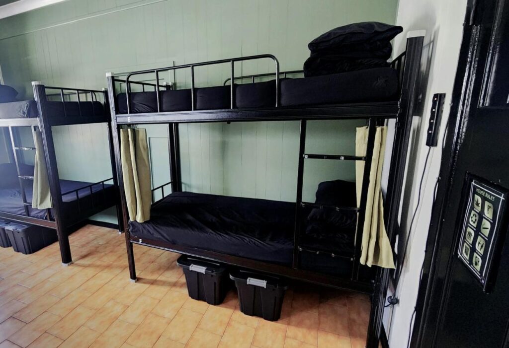 Four bed dormitory with black bedding at Wanna Stay Hostel