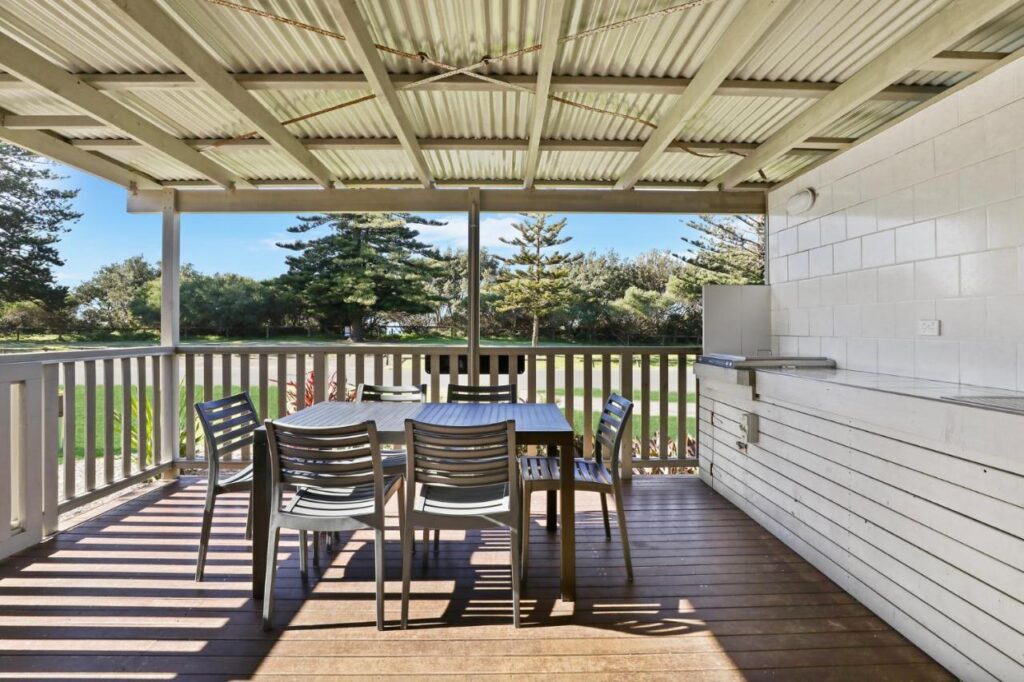 Amaizing outdoor BBQ facilities ready to cook up a storm! This on on a deck with a table at Werri Beach Holiday Park