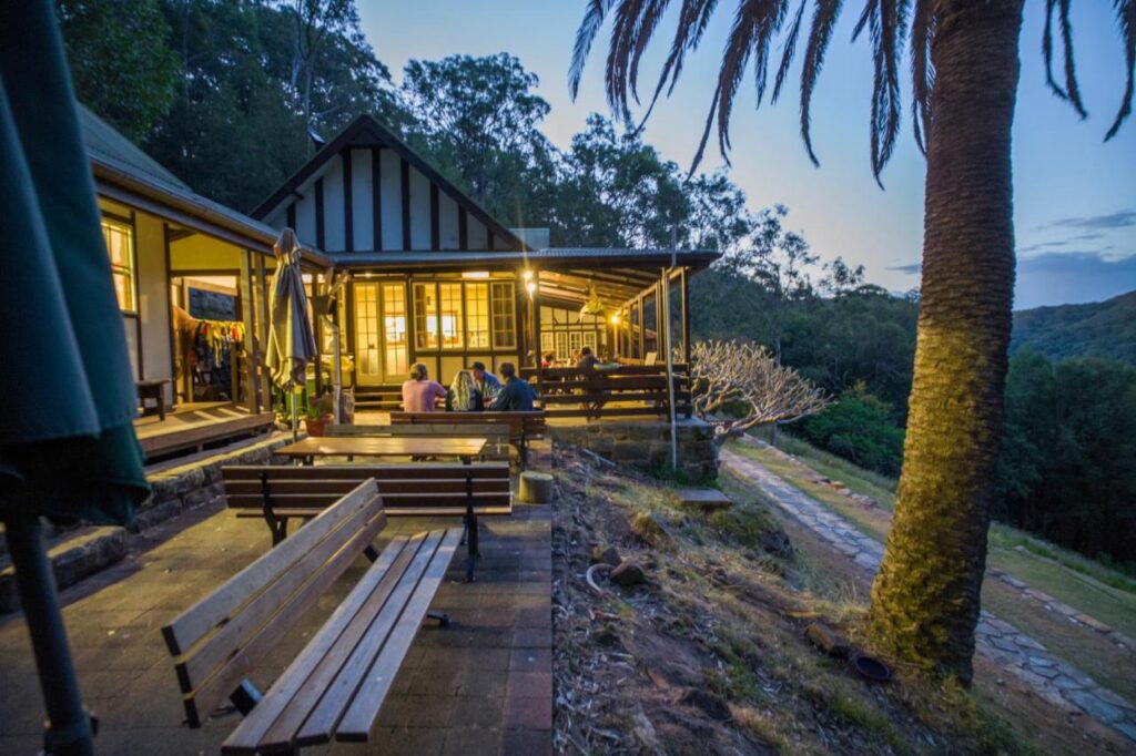 Travellers relaxing and enjoying themselves in the evening while at YHA Pittwater Eco Sydney