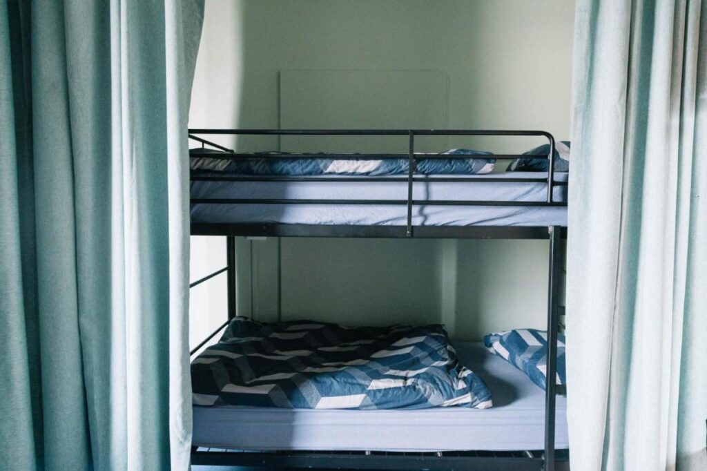 A dormitory with bunk beds and a curtain to make some privacy at Carric Hostel