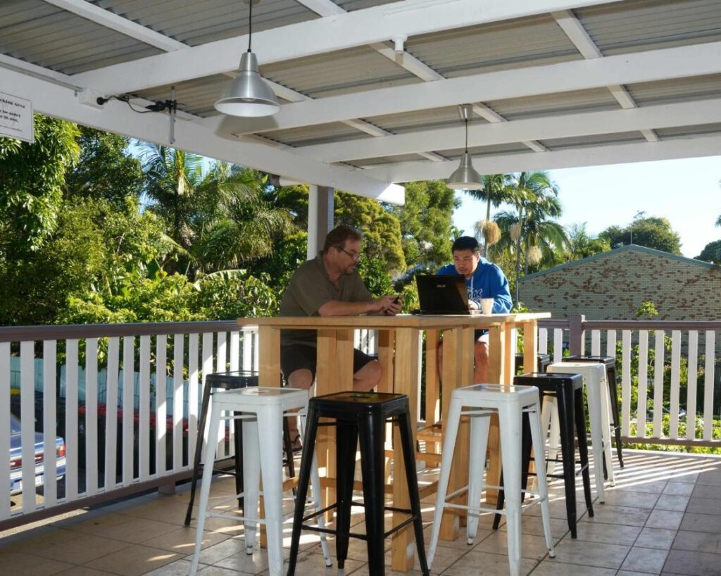 Travellers and gusts sitting in the verandah while surfing the net at Gonow Family Backpackers Hostel