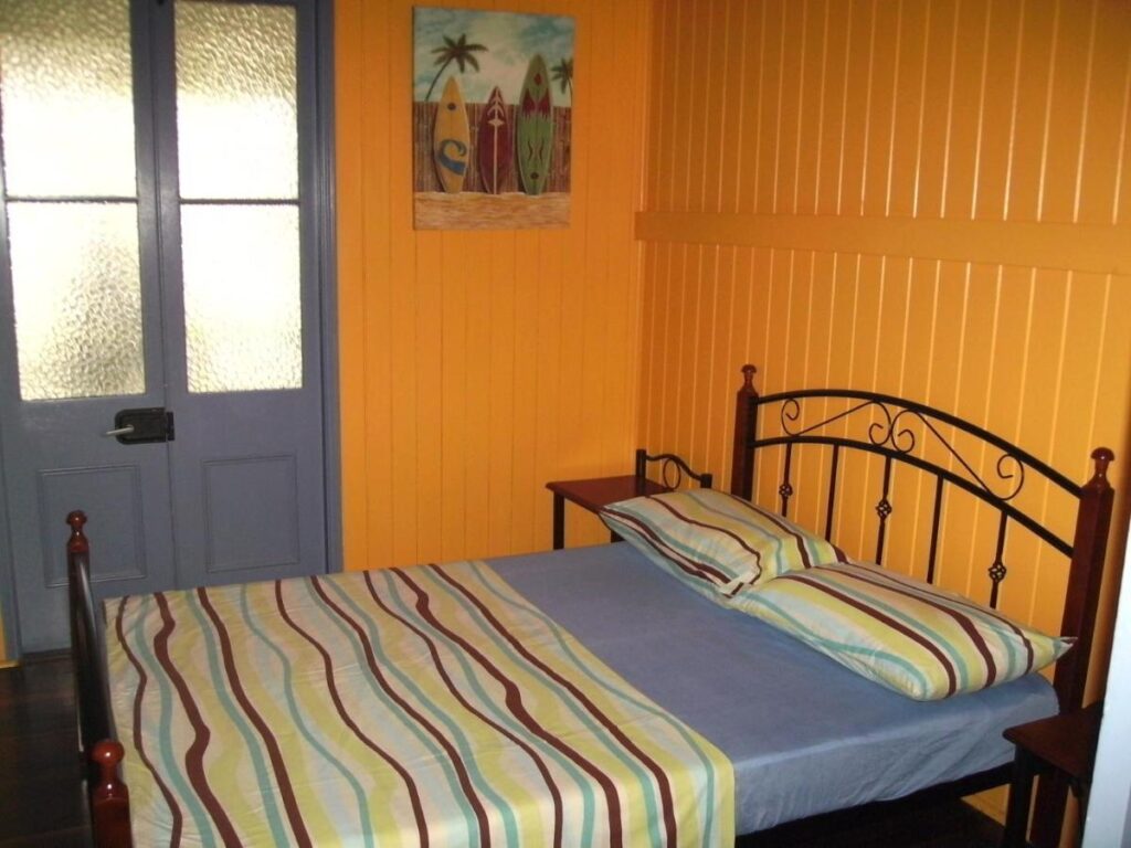 A private room with a queen sixed bed with direct outdoor access at Mango Tourist Hostel