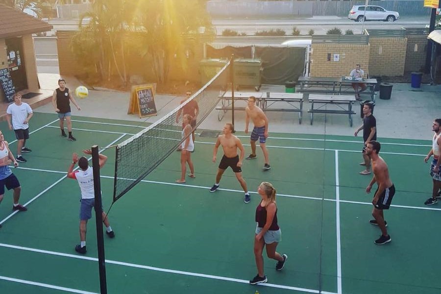 Travellers playing volleyball in the afternoon at Maxmee Backpackers Resort