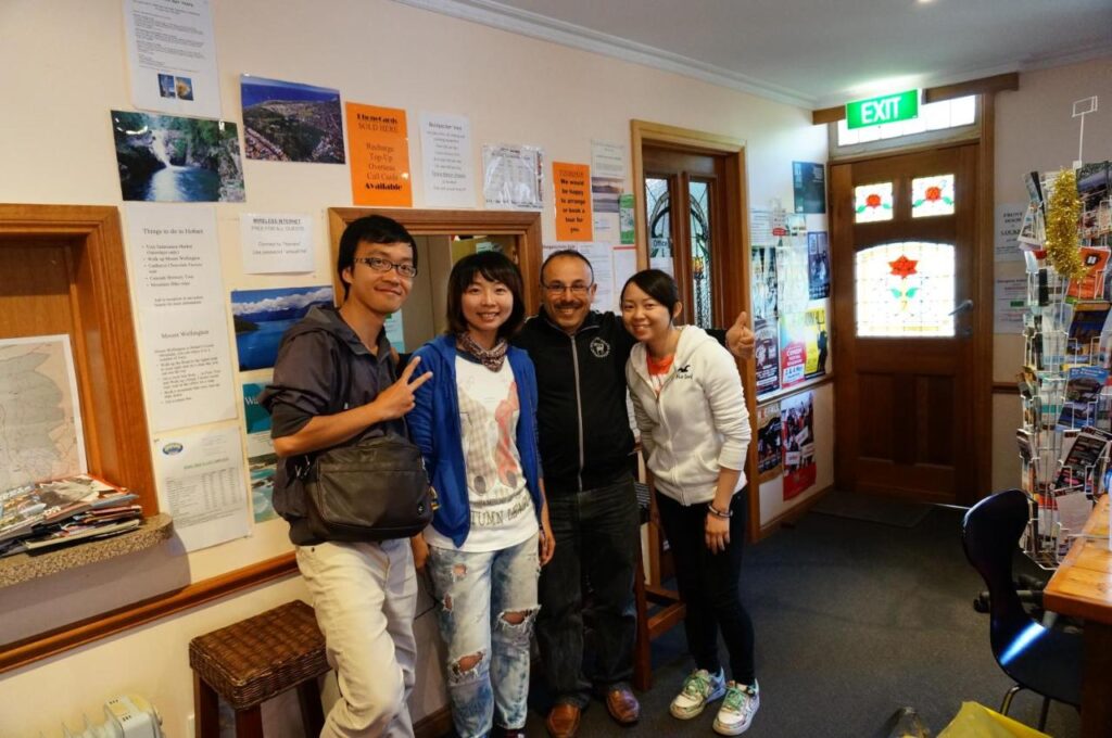 Friendly staff posing for a photo with three guests staying at Narrara Backpackers