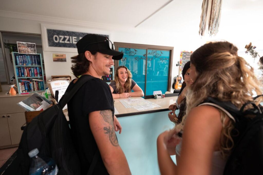 Guests checking in at the friendly and welcoming reception at Ozzie Pozzie Backpackers