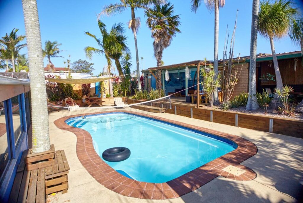 The swimming pool where travellers play volleyball and relax in the sun at Ozzie Pozzie Backpackers