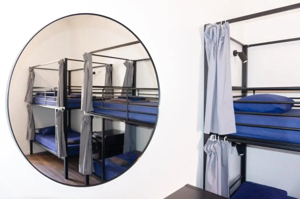 A mixed four bed dormitory with curtain for privacy when sleeping at Somewhere To Stay Backpackers