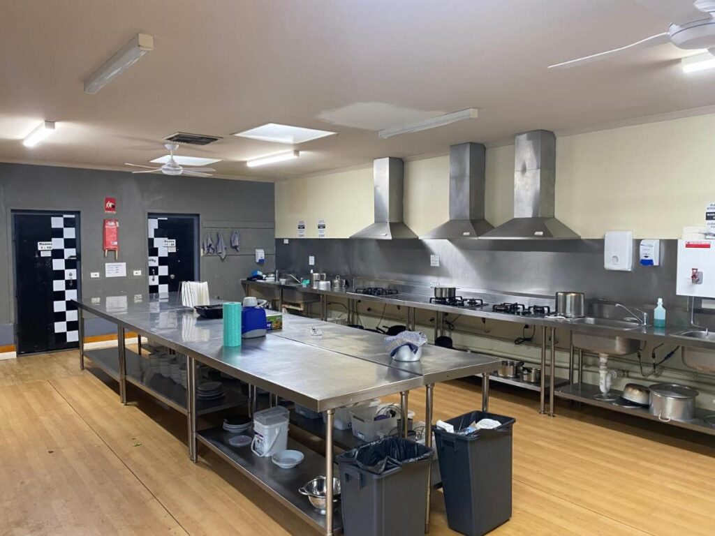 A shared kitchen with stainless steel bench tops at Sunraysia Stays