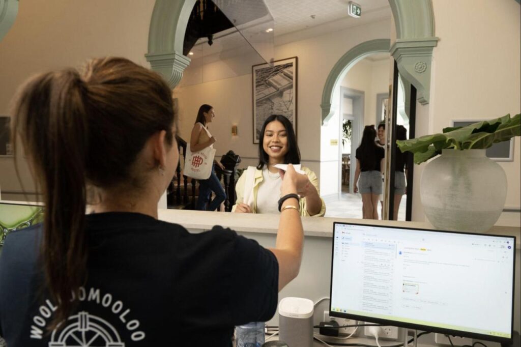 Friendly staff assistng a traveller to book in at The Pacific House